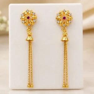 Gold plated floral jhumka earrings with ruby red stone, AD stones and long chain tassels